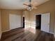 Bright bedroom with ceiling fan, wood-look floors, and ample closet space at 238 Seabert Rd. # 238, Myrtle Beach, SC 29579