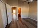 Bedroom featuring hardwood-style floors and natural light with a view to the bathroom and hallway at 238 Seabert Rd. # 238, Myrtle Beach, SC 29579