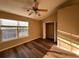 Cozy bedroom featuring wood-look floors, a ceiling fan, and a window for natural light at 238 Seabert Rd. # 238, Myrtle Beach, SC 29579