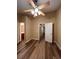 Large bedroom with hardwood-style floors, ceiling fan, an ensuite bath and closet at 238 Seabert Rd. # 238, Myrtle Beach, SC 29579