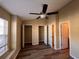 Spacious bedroom with wood-look floors, a ceiling fan, closet and an ensuite bath at 238 Seabert Rd. # 238, Myrtle Beach, SC 29579