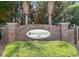 Entrance to Sawgrass East, a Portrait Homes community, with brick pillars and lush greenery at 238 Seabert Rd. # 238, Myrtle Beach, SC 29579