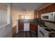 Open kitchen with granite counters, tile backsplash, and white appliances, offering views to the living area at 238 Seabert Rd. # 238, Myrtle Beach, SC 29579