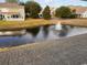 Backyard pond view features a fountain, lush grass, and townhomes in the distance at 238 Seabert Rd. # 238, Myrtle Beach, SC 29579