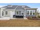 A tranquil backyard patio setup with outdoor seating and landscaped garden view at 2615 Elowen Ln. # 109A, Longs, SC 29568