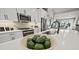 White gourmet kitchen with island sink and living area beyond at 2615 Elowen Ln. # 109A, Longs, SC 29568