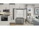 A modern kitchen with stainless steel appliances, white cabinetry, and an open refrigerator at 2615 Elowen Ln. # 109A, Longs, SC 29568
