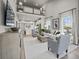 Open-concept living room with a loft above, modern furniture, and contemporary decor at 2615 Elowen Ln. # 109A, Longs, SC 29568