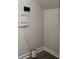 A neatly wired, gray-walled storage area with an Orbi WiFi system component on a wood floor at 2615 Elowen Ln. # 109A, Longs, SC 29568