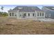 View of the backyard featuring a new patio and construction ladders near the house at 2616 Elowen Ln. # 167B, Longs, SC 29568
