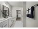 Stylish bathroom featuring double vanity, white cabinets, and access to a large walk-in closet at 2616 Elowen Ln. # 167B, Longs, SC 29568