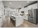 Open concept kitchen with white cabinets, stainless steel appliances, and a large island with seating at 2616 Elowen Ln. # 167B, Longs, SC 29568
