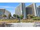 Beachfront view of the building with lush landscaping at 2701 N Ocean Blvd. # 1260, Myrtle Beach, SC 29577