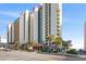 An attractive multi-story condo complex with well-manicured landscaping near a sandy beach at 2701 N Ocean Blvd. # 1260, Myrtle Beach, SC 29577