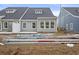 New construction backyard awaiting landscaping, showcasing the home's clean exterior at 2703 Elowen Ln. # 111B, Longs, SC 29568
