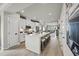 Open-concept kitchen with white cabinets, stainless steel appliances, and a center island at 2703 Elowen Ln. # 111B, Longs, SC 29568