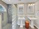Bright bathroom with dual pedestal sinks, glass block shower, and stylish fixtures at 28 Torrens Pl., Pawleys Island, SC 29585