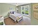 Cozy bedroom with a large window, ceiling fan, and neutral carpet at 28 Torrens Pl., Pawleys Island, SC 29585