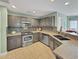 Modern kitchen featuring granite countertops, stainless steel appliances, and ample cabinet space, perfect for culinary enthusiasts at 28 Torrens Pl., Pawleys Island, SC 29585