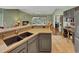 An open kitchen features granite counters and dark cabinetry with view into adjacent living room at 28 Torrens Pl., Pawleys Island, SC 29585