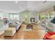 Bright living room with hardwood floors, a fireplace, and access to an outdoor patio, creating a cozy and inviting space at 28 Torrens Pl., Pawleys Island, SC 29585