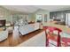 Spacious living area featuring hardwood floors, a cozy fireplace, and a seamless transition to the kitchen and dining space at 28 Torrens Pl., Pawleys Island, SC 29585
