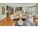 Open-concept living room with hardwood floors, a comfortable sofa, and seamless flow to the kitchen and dining area at 28 Torrens Pl., Pawleys Island, SC 29585