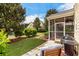 Backyard featuring a screened in porch with outdoor seating, and lush landscaping at 306 River Rock Ln. # 1306, Murrells Inlet, SC 29576