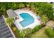 Aerial view of a refreshing community pool surrounded by lounge chairs and palm trees at 306 River Rock Ln. # 1306, Murrells Inlet, SC 29576
