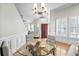 Cozy dining area with glass table, hardwood floors, and views to the living room at 306 River Rock Ln. # 1306, Murrells Inlet, SC 29576
