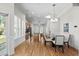 Bright and open dining area with hardwood floors and views into the kitchen at 306 River Rock Ln. # 1306, Murrells Inlet, SC 29576