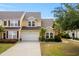 Inviting two-story home with a two-car garage, well-manicured lawn, and beautiful landscaping at 306 River Rock Ln. # 1306, Murrells Inlet, SC 29576