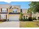 Charming two-story home with a two-car garage, manicured lawn, and beautiful landscaping at 306 River Rock Ln. # 1306, Murrells Inlet, SC 29576