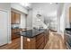 Open kitchen area featuring a large island, granite countertops, stainless steel appliances, and hardwood flooring at 306 River Rock Ln. # 1306, Murrells Inlet, SC 29576