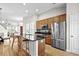 Open kitchen with a central island, stainless steel appliances, wooden cabinetry, and an open floorplan at 306 River Rock Ln. # 1306, Murrells Inlet, SC 29576
