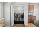 Convenient laundry closet with side-by-side washer and dryer, adjacent to kitchen cabinets at 306 River Rock Ln. # 1306, Murrells Inlet, SC 29576