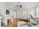 Bright living room with hardwood floors, neutral decor, and plenty of natural light from plantation shutters at 306 River Rock Ln. # 1306, Murrells Inlet, SC 29576