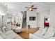 Open-concept living room with hardwood floors, neutral paint, and staircase at 306 River Rock Ln. # 1306, Murrells Inlet, SC 29576