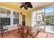Inviting screened porch with tile flooring, ceiling fan, and outdoor dining area at 306 River Rock Ln. # 1306, Murrells Inlet, SC 29576