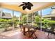 Cozy screened porch with tile flooring and dining table, surrounded by lush greenery at 306 River Rock Ln. # 1306, Murrells Inlet, SC 29576