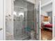 A glass-enclosed walk-in shower features a bench and rainfall shower head at 306 River Rock Ln. # 1306, Murrells Inlet, SC 29576