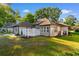 Backyard with patio featuring brick home exterior, manicured lawn and mature trees at 3107 Robyn Ct., Little River, SC 29566
