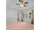 Spacious bedroom featuring a ceiling fan, carpet, and french doors to a patio at 3107 Robyn Ct., Little River, SC 29566
