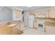Well-lit kitchen featuring granite countertops, white appliances, and tiled flooring at 3107 Robyn Ct., Little River, SC 29566