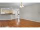 Open-concept living room with hardwood floors and a view to the kitchen with updated appliances at 3107 Robyn Ct., Little River, SC 29566