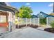 Back patio area with white lattice fence leading to a sunroom on a beautiful partially cloudy day at 3107 Robyn Ct., Little River, SC 29566