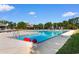 A serene community pool area with lounge chairs and blue umbrellas, great for relaxation and recreation at 3107 Robyn Ct., Little River, SC 29566