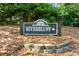 Community entrance sign for Riverbluff, set amidst lush greenery and stone details at 3107 Robyn Ct., Little River, SC 29566