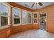 Bright sunroom with neutral tile floor, many windows and an exterior door at 3107 Robyn Ct., Little River, SC 29566