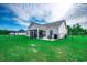 Beautifully landscaped backyard with a screened-in porch, lush green grass, and mature trees for privacy at 3148 Gause Rd., Loris, SC 29569